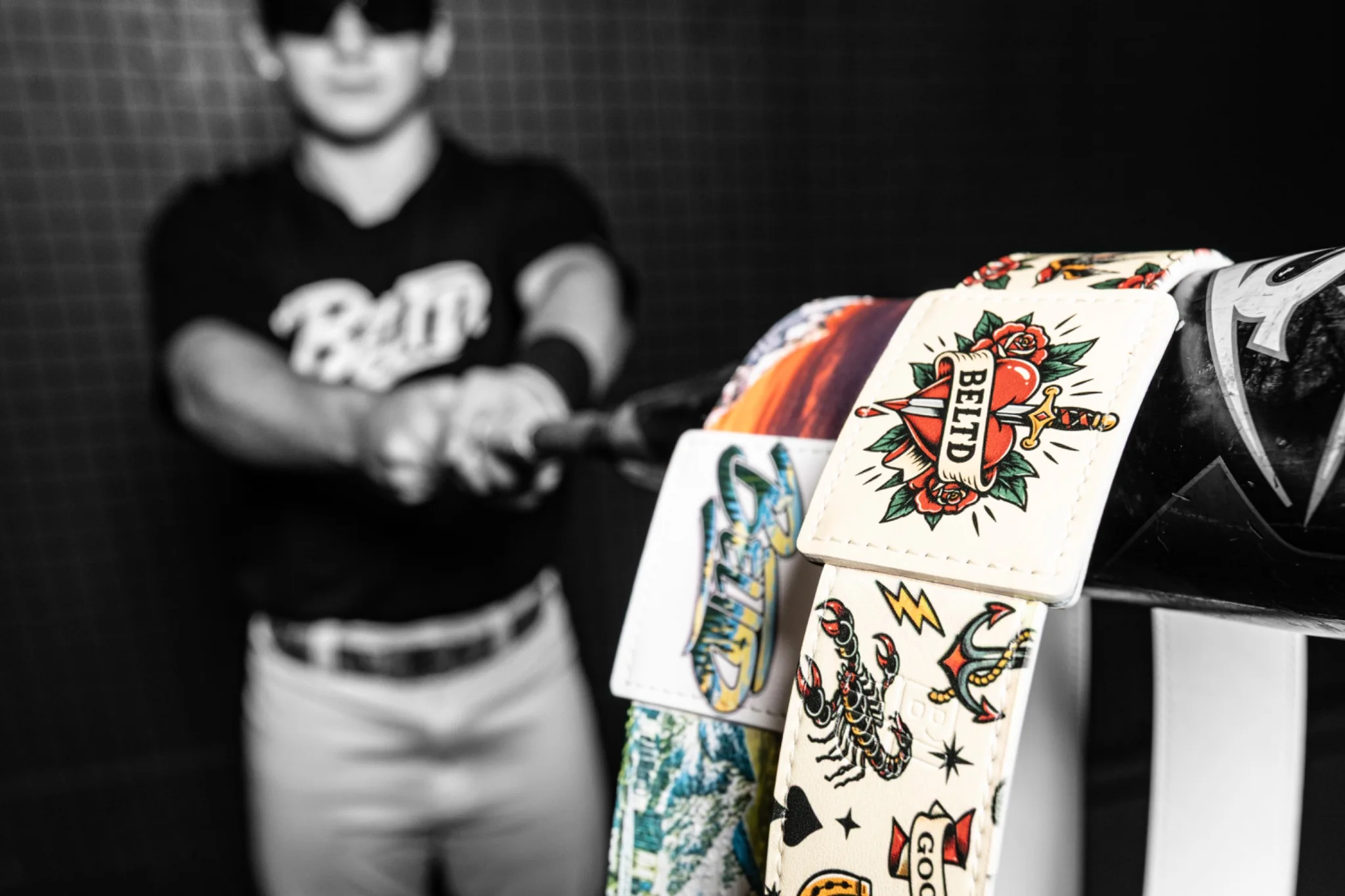 Custom BELTD belts photographed in a batting cage