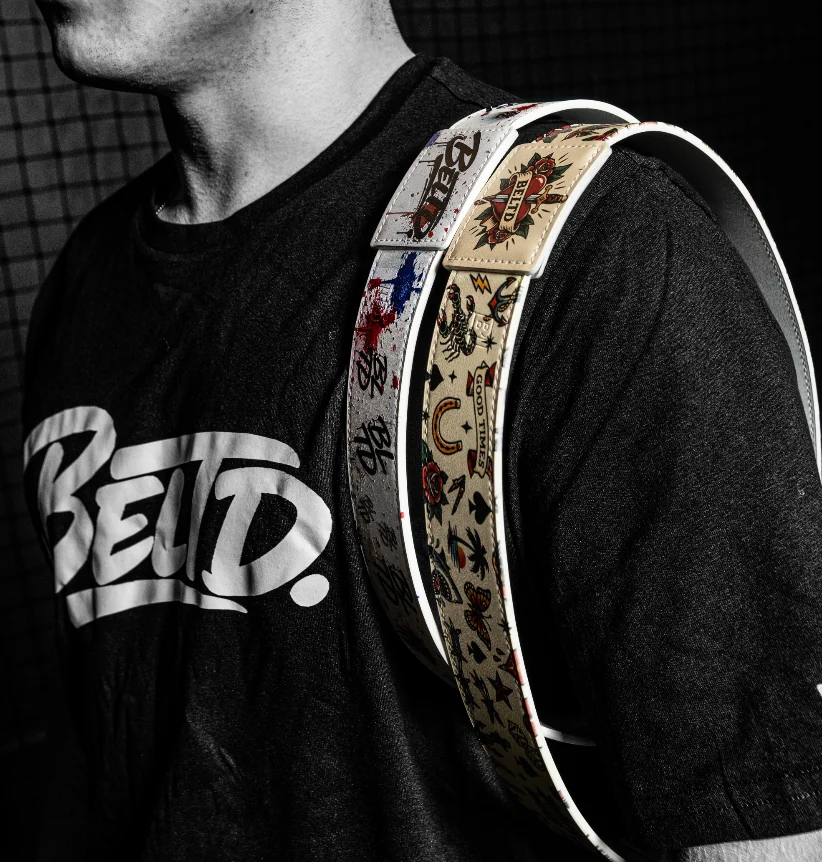 BELTD athlete carrying two custom belts over his shoulder